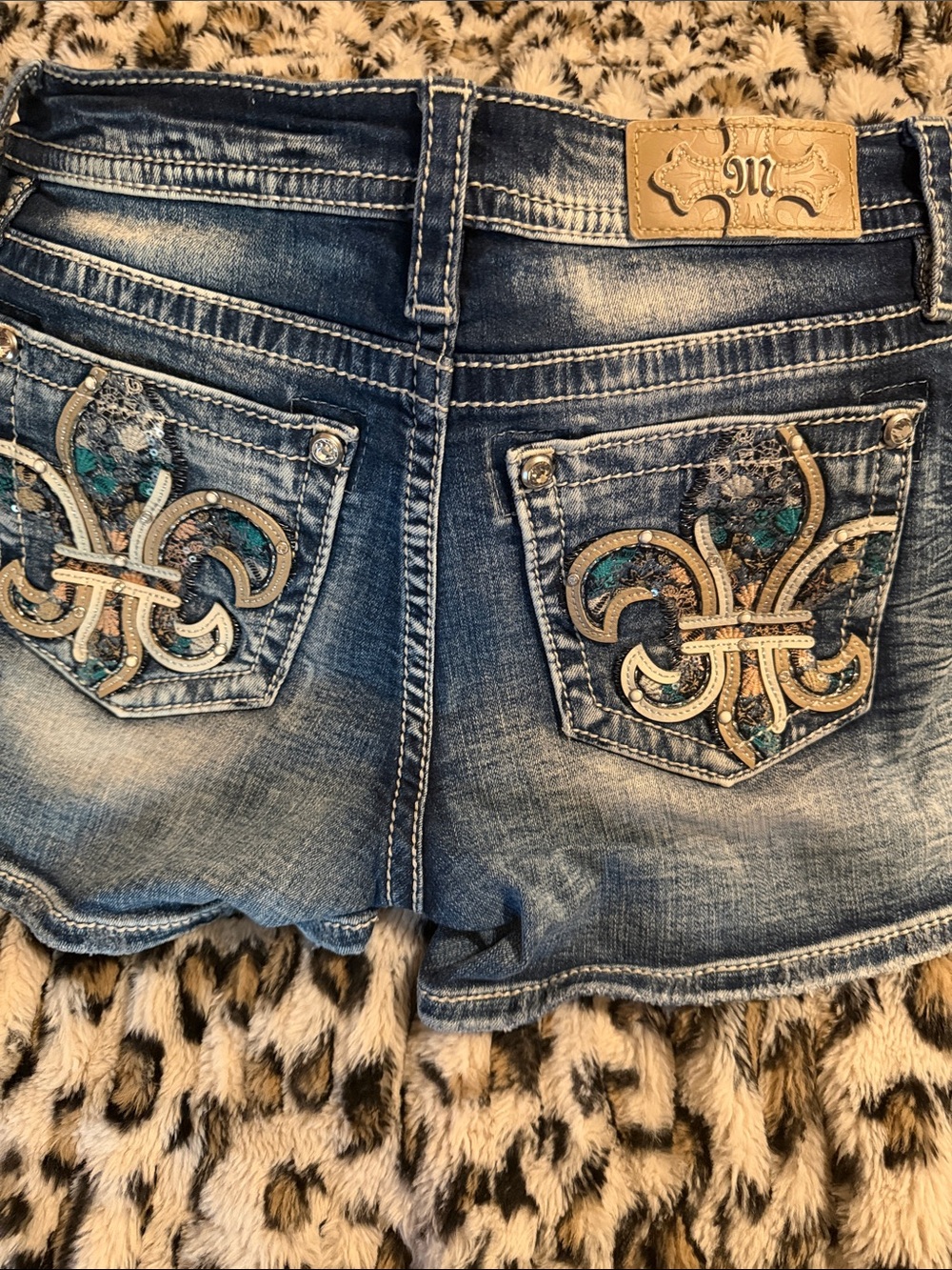 Miss Me Distressed Blue Denim Shorts with Embellished Fleur-de-Lis Pockets